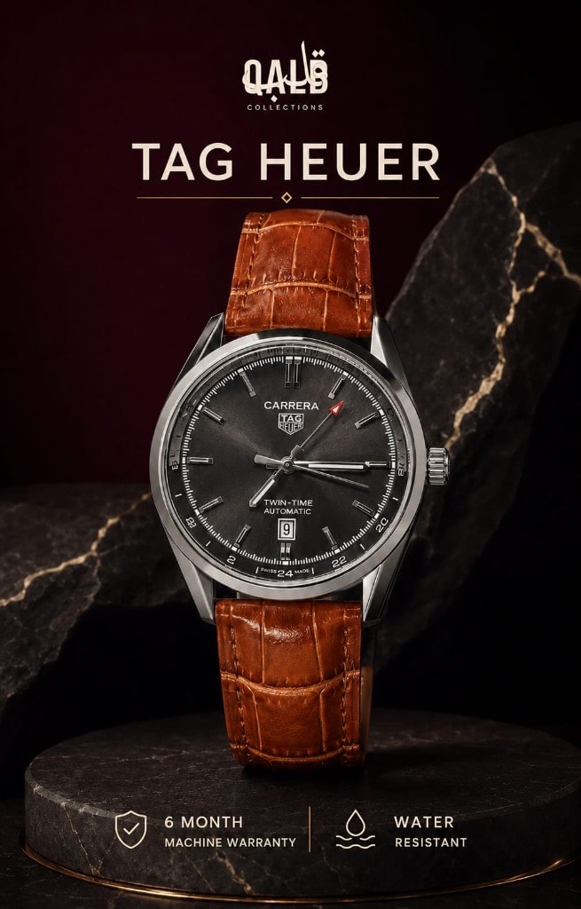 TAG Heuer Carrera Twin-Time Automatic on a marble pedestal against a burgundy atelier backdrop